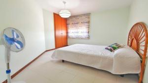 a bedroom with a bed and a fan at Apartamento Costamar by VACAY L'Escala in L'Escala
