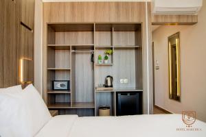 a bedroom with a bed and a kitchen in it at Marchica Hotel in Nador