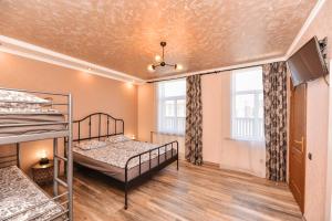 a bedroom with two bunk beds and a tv at Meldernams in Ventspils