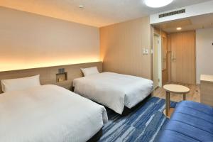 Voodi või voodid majutusasutuse Nagoya Sakae Washington Hotel Plaza toas