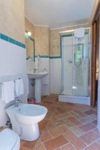 a bathroom with a toilet and a sink and a shower at Locanda di Montegiove in Fano