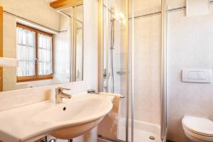 a bathroom with a sink and a shower at Schreiberhof Landhaus in Laion +22 photos