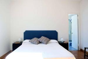 a bedroom with a large bed with two pillows on it at Villa San Sisinnio Argegno in Argegno +24 photos
