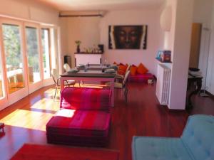 a living room with a table and some chairs at Villa San Sisinnio Argegno in Argegno