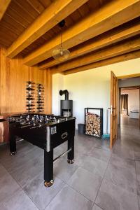 a ping pong table in a room with a fireplace at Chata Viola in Dolní Morava