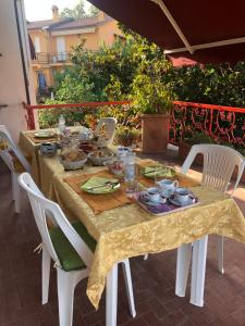 a table with chairs and a table cloth on a patio at B&b ANNA in Bolsena +38 photos