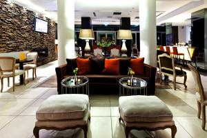 a lobby of a hotel with a couch and chairs at Olympus Thea Boutique Hotel in Platamonas
