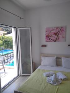 a bedroom with a bed and a sliding glass door at Oasis in Parga