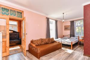 a living room with a couch and a bed at Villa Victoria in Ventspils