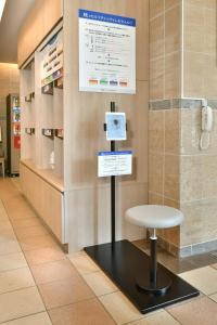 a display in a pharmacy with a stool in a room at Nagoya Sakae Washington Hotel Plaza in Nagoya