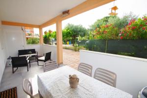a table with a vase on it on a patio at Apartment Pineta in village Valbandon in Valbandon