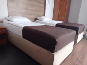 two beds in a hotel room with two bedsskirts at Volyn in Volodymyr-Volynskyi