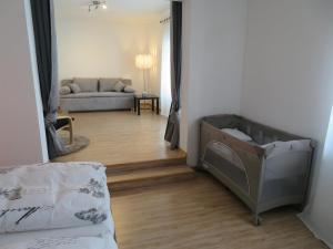 a living room with a bed and a couch at Ferienwohnung Scheer 