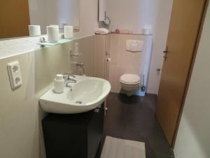 a bathroom with a sink and a toilet at Ferienwohnung Scheer 