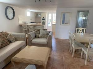 a living room with a couch and a table at La Cour des Cloches in Mainxe