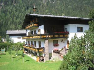 a large building with balconies on the side of it at Landhaus Penker in Mallnitz