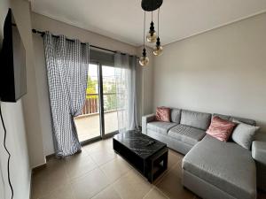 a living room with a couch and a window at EVa's Luxury Apartments No 2 in Áyios Spirídhon