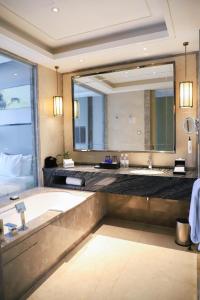 a bathroom with two sinks and a large mirror at Wanda Realm Nanchang in Nanchang