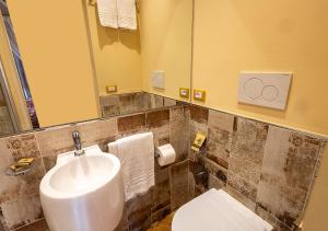 a bathroom with a sink and a toilet and a mirror at B&B Belcuore in Macerata +32 photos