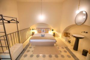 a bedroom with a bed in a room with a staircase at Chic duplex maisonette in Valletta centre-DDEM4 in Valletta