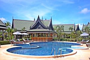 a swimming pool in front of a building at Airport Resort Phuket in Nai Yang Beach