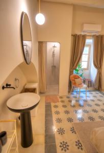 a bathroom with a sink and a mirror at Chic duplex maisonette in Valletta centre-DDEM4 in Valletta