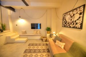 a living room with a couch and a tv at Chic duplex maisonette in Valletta centre-DDEM4 in Valletta