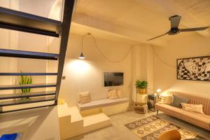 a living room with a couch and a tv at Chic duplex maisonette in Valletta centre-DDEM4 in Valletta
