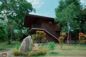 a building with a staircase in a park at Doola River Edge in Udawalawe