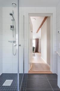 a bathroom with a shower with a glass door at Hotell MAVI in Viken