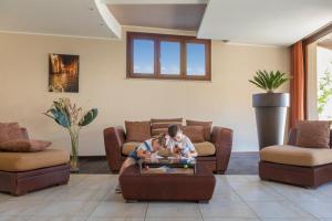 a boy and a girl playing in a living room at Villa Zina Family Resort in Custonaci