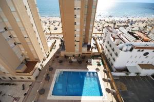 an overhead view of a building with a swimming pool and a beach at Doña Amparo chipiona Playa de Regla in Chipiona