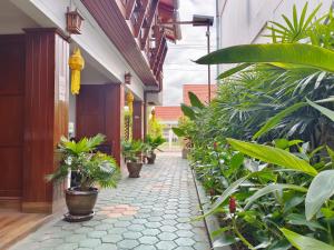 a courtyard of a house with potted plants at Aphilapa Residence in Chiang Mai