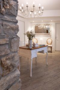 a dining room with a table and a stone wall at BeB San Lorenzo in Bergamo