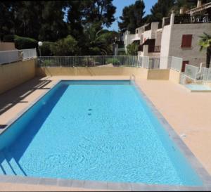 a large blue swimming pool in a building at STUDIO 109 GRANDE TERRASSE Mer proche in Bandol