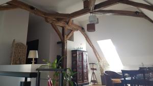 a room with wooden beams and a table and chairs at Les 7 Tilleuls - Chambres d'hôtes in Mesland