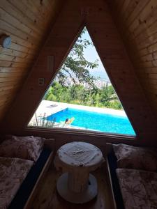 a view of a swimming pool from a room with a window at Bungalovi Lana in Sarajevo