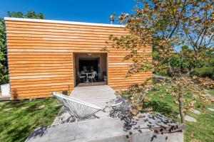 a wooden building with a table and a chair at The Urban Tramping Hut in Rotorua