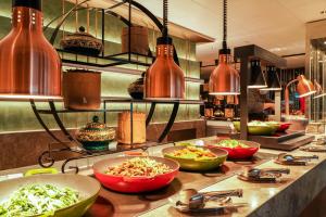 a kitchen with bowls of food on a counter at Pullman Shanghai Skyway in Shanghai