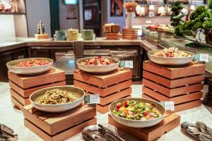 a display of bowls of food in a store at Pullman Shanghai Skyway in Shanghai