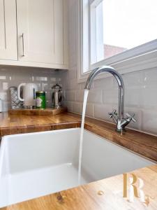 a sink in a kitchen with a faucet at Fisherman's Cottage - Harwich Breaks - BRAND NEW - long stays available great prices - get in touch for all bookings - cottage in harwich - beach stay in Harwich