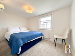 a bedroom with a bed and a chair and a window at Fisherman's Cottage - Harwich Breaks - BRAND NEW - long stays available great prices - get in touch for all bookings - cottage in harwich - beach stay in Harwich