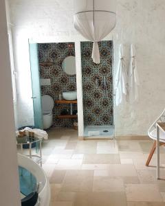 a bathroom with a mirror and a sink and a toilet at Donna Piera - Dimore di Charme in Monopoli