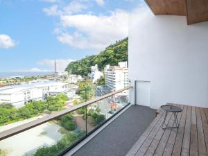 a balcony with a view of a city at Rakuten STAY Atami in Atami