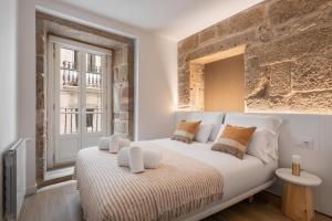 Кровать или кровати в номере Bow Monumental by Como en Casa