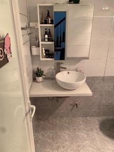 a bathroom with a white sink and a mirror at Green Homestay in Hanoi