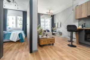 a room with a bed and a desk and a chair at Margi Soho Apartament in Szczecin
