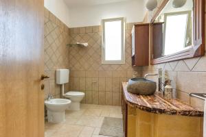 a bathroom with a toilet and a sink at Tenuta Gianfredi by BarbarHouse in Casarano