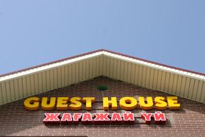 a close up of a guest house sign on a building at Guest House Dostar - Жағажай Үй Достар in Aktau