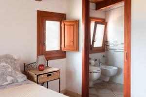 a small bathroom with a toilet and a sink at Sa Guardia de Ferricci in Solanas